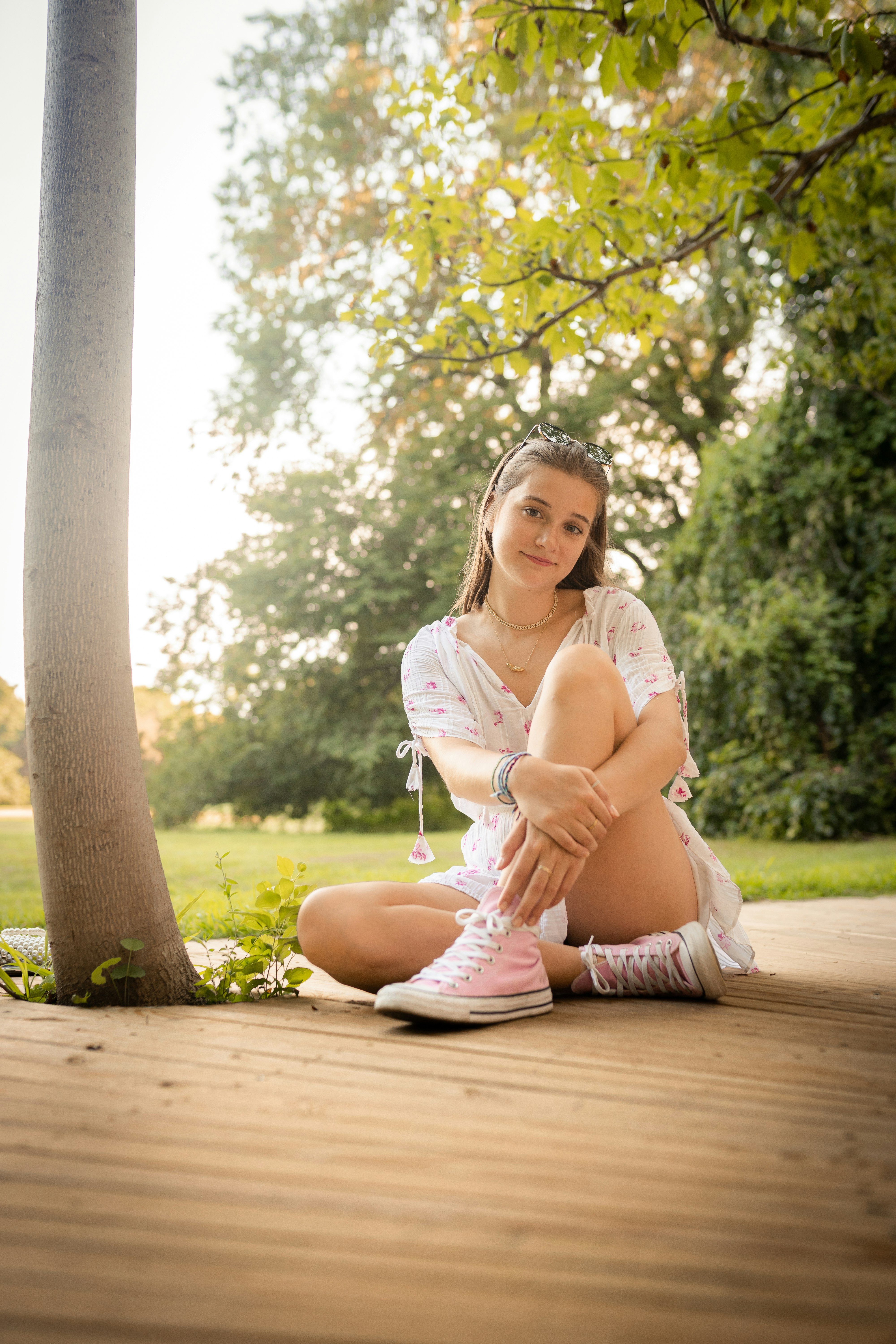 woman in white dress sitting on brown wooden floor